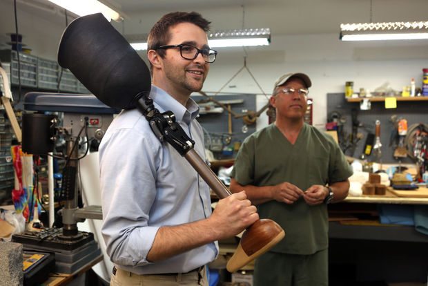 image of Michael Mabry holding a prosthetic leg