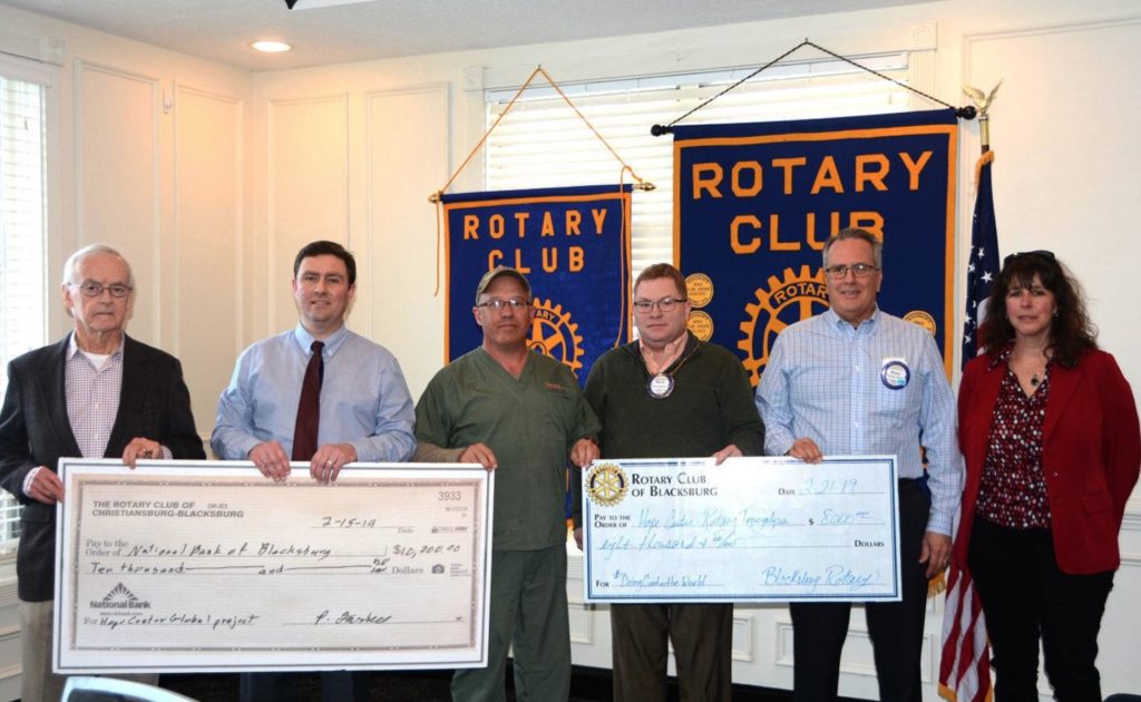 image of people holding giant cheques